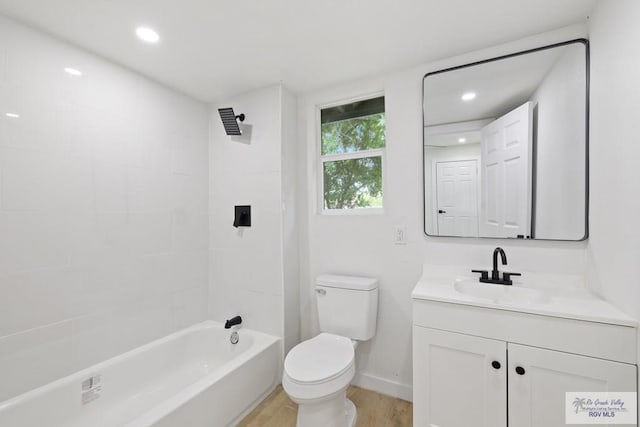 1522 Ball St, Harlingen, TX 78550 - bathroom with vanity, wood finished floors,  shower combination, and recessed lighting