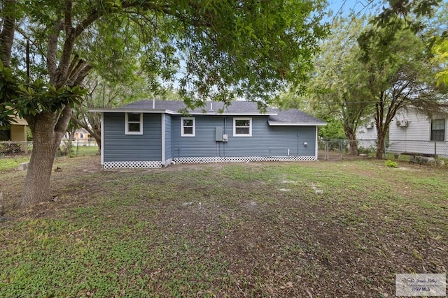 1522 Ball St, Harlingen, TX 78550 - rear view of house featuring a fenced backyard and a shingled roof