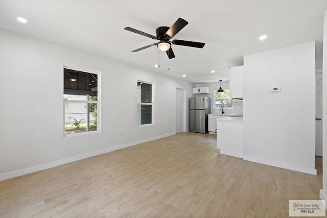 1522 Ball St, Harlingen, TX 78550 - unfurnished living room featuring a ceiling fan, recessed lighting, and light wood-style flooring