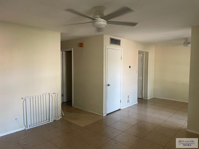 2402 Ed Carey Dr Unit 33, Harlingen, TX 78550 - empty room with ceiling fan and tile patterned flooring