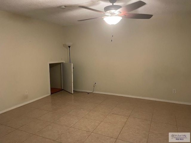 2402 Ed Carey Dr Unit 33, Harlingen, TX 78550 - spare room with a ceiling fan, light tile patterned floors, and a textured ceiling