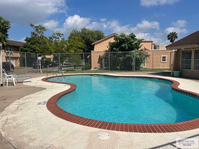 2402 Ed Carey Dr Unit 33, Harlingen, TX 78550 - community pool featuring a patio area