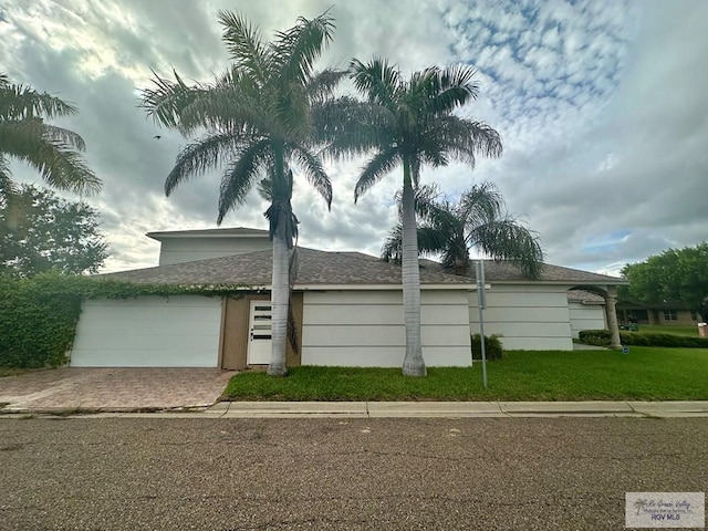 view of front of house with a front yard and a garage