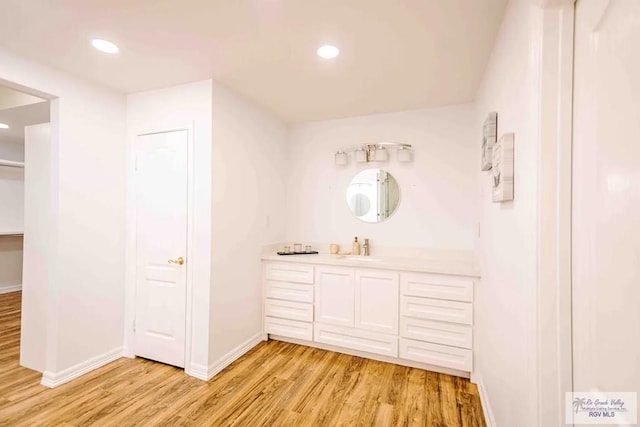 bathroom featuring hardwood / wood-style flooring and vanity