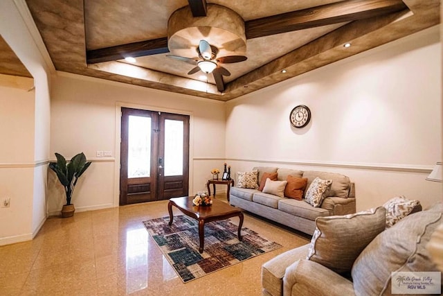 living room with french doors, a raised ceiling, and ceiling fan