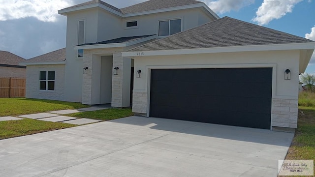 view of front of property featuring a garage and a front yard