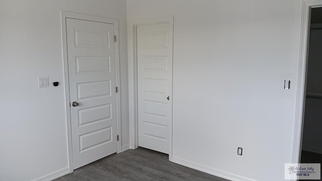 unfurnished bedroom featuring dark hardwood / wood-style floors