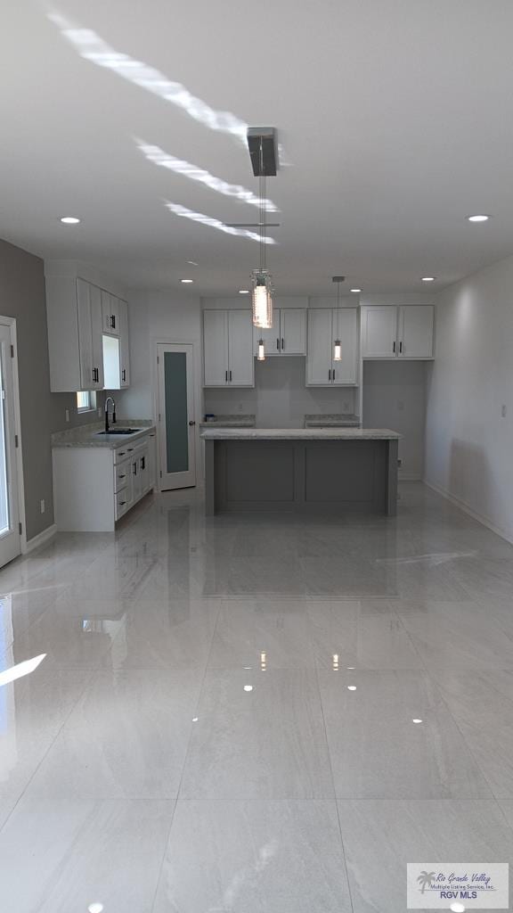 kitchen with decorative light fixtures and sink