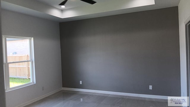 empty room featuring ceiling fan and plenty of natural light