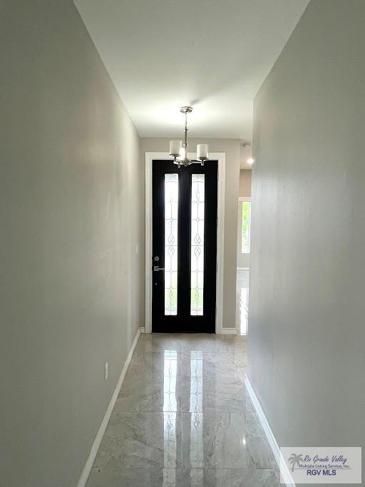 foyer featuring a notable chandelier