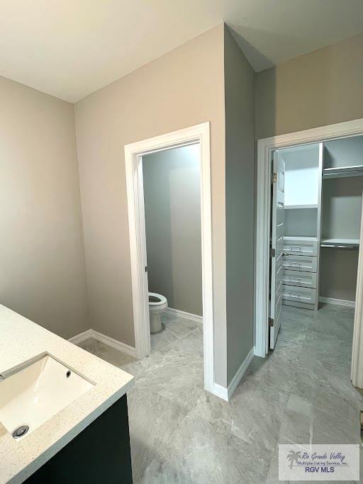 bathroom featuring vanity and toilet