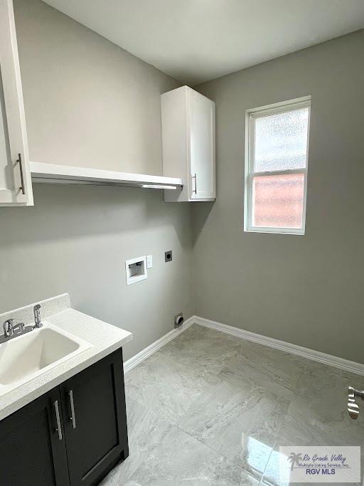 laundry room featuring hookup for a washing machine, sink, cabinets, and hookup for an electric dryer