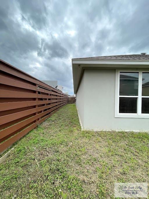 view of side of property with a yard