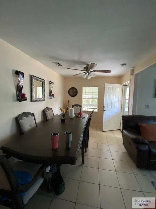 tiled dining room featuring ceiling fan