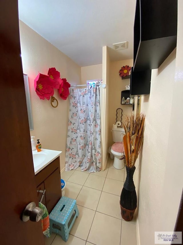 bathroom with tile patterned flooring, vanity, a shower with shower curtain, and toilet