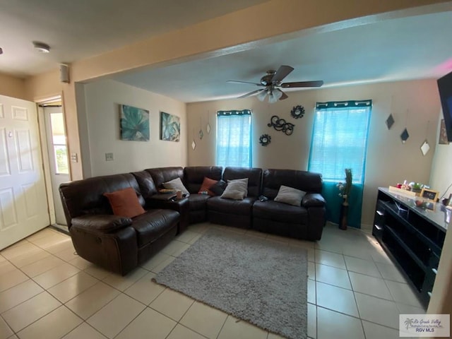 tiled living room featuring a wealth of natural light and ceiling fan