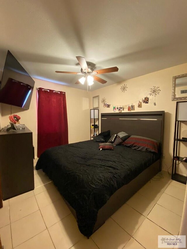 bedroom featuring ceiling fan and light tile patterned flooring