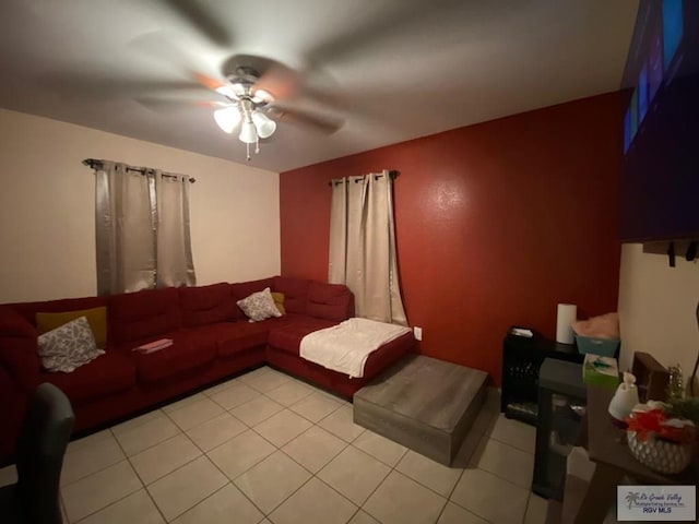 living room with ceiling fan and light tile patterned floors