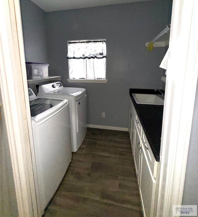 201 Terrace Ln, Harlingen, TX 78550 - laundry room with cabinet space, washing machine and dryer, dark wood-style flooring, and baseboards