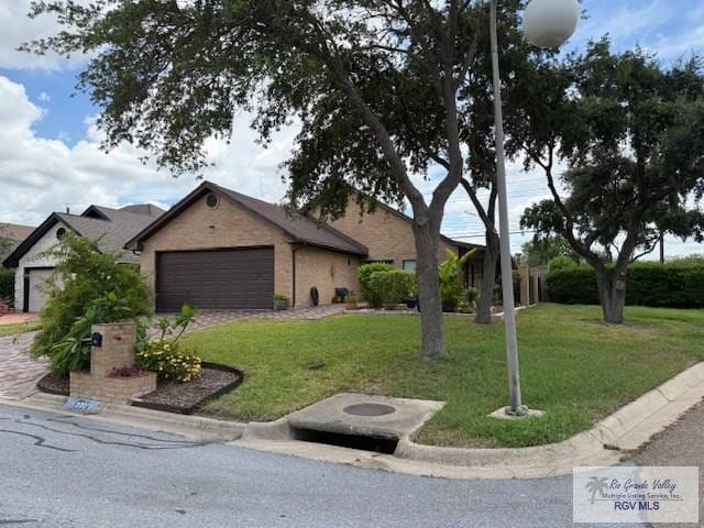 201 Terrace Ln, Harlingen, TX 78550 - view of front of property with a garage, a front lawn, and brick siding
