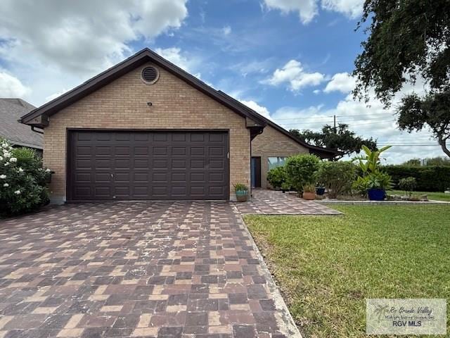 201 Terrace Ln, Harlingen, TX 78550 - ranch-style house with brick siding, a front lawn, driveway, and a garage