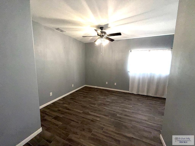 201 Terrace Ln, Harlingen, TX 78550 - spare room featuring a ceiling fan, dark wood-style flooring, and baseboards