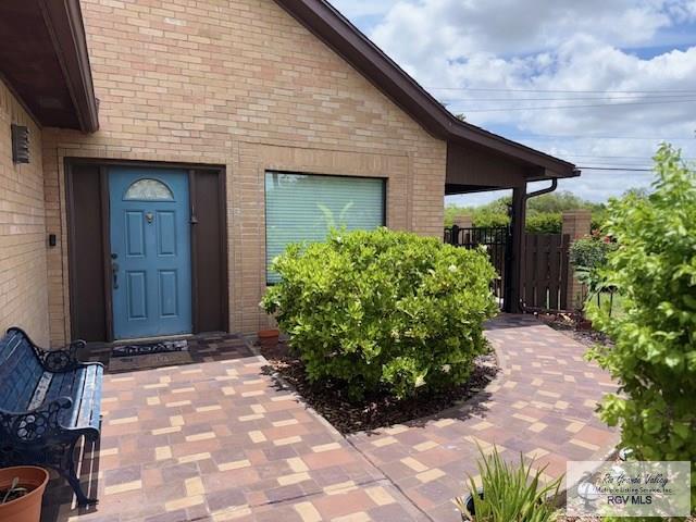 201 Terrace Ln, Harlingen, TX 78550 - doorway to property featuring brick siding