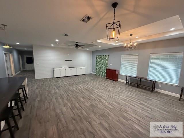 201 Terrace Ln, Harlingen, TX 78550 - unfurnished living room featuring wood finished floors, baseboards, ceiling fan, recessed lighting, and a chandelier