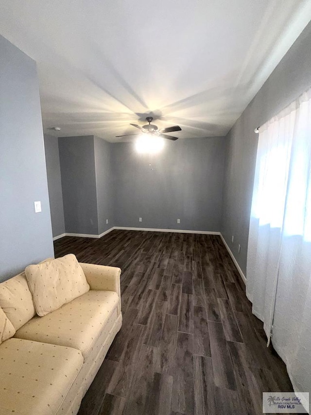 201 Terrace Ln, Harlingen, TX 78550 - unfurnished living room featuring a ceiling fan, dark wood-style floors, and baseboards