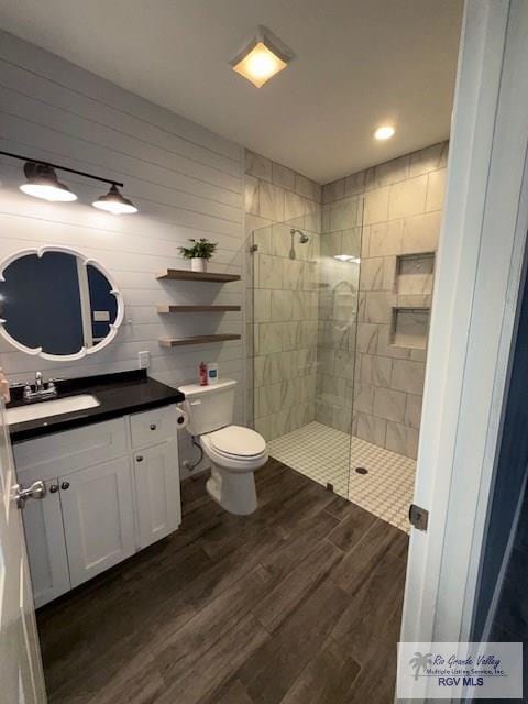 201 Terrace Ln, Harlingen, TX 78550 - full bathroom with vanity, a walk in shower, wood finished floors, toilet, and recessed lighting