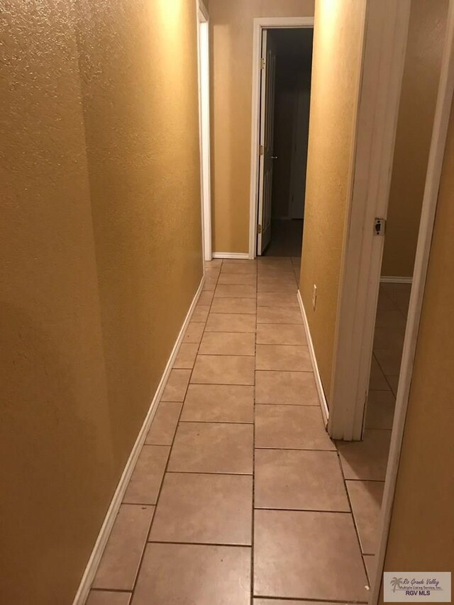 corridor featuring light tile patterned flooring