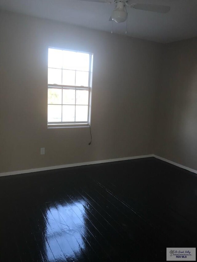 spare room featuring ceiling fan and wood-type flooring