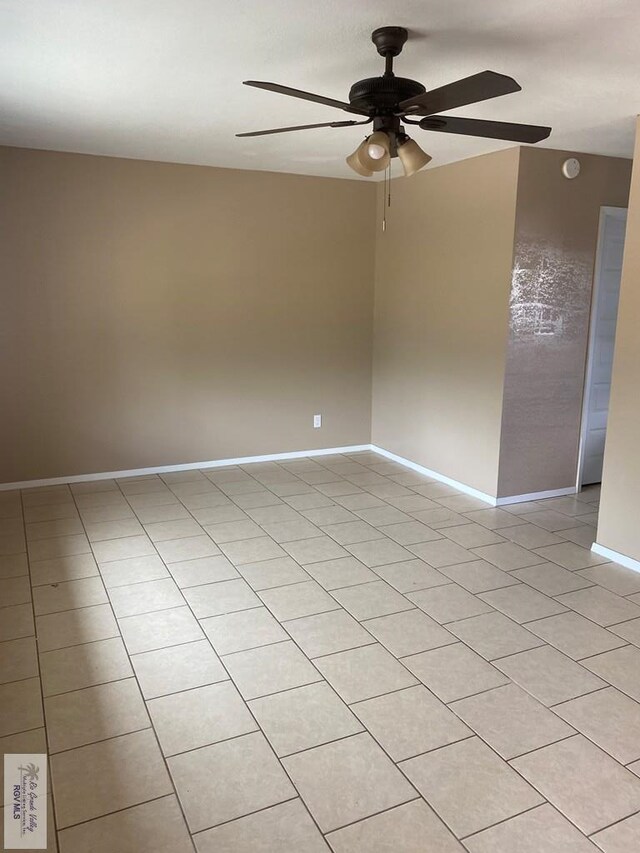 unfurnished room with ceiling fan and light tile patterned floors