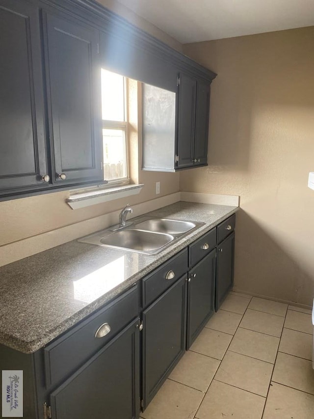 kitchen featuring light tile patterned flooring and sink