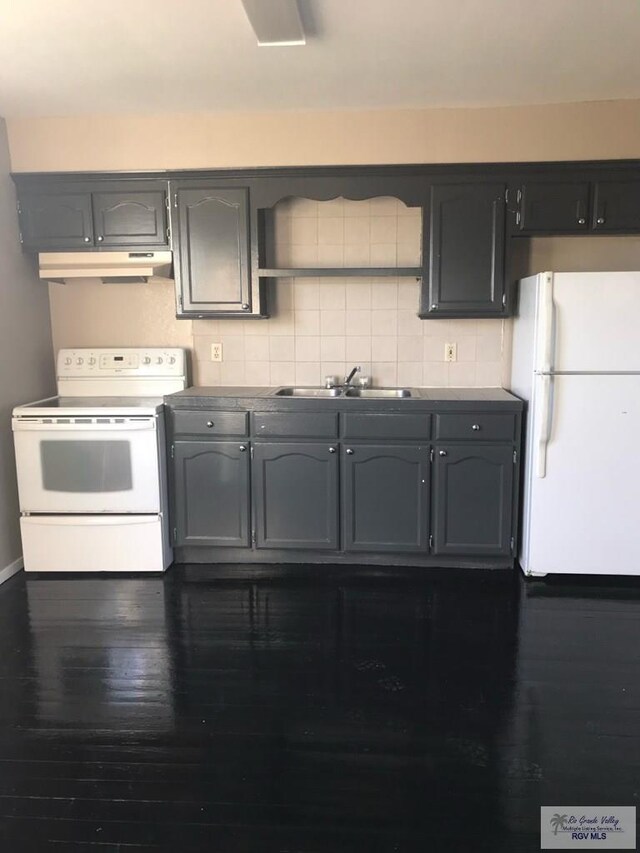 kitchen featuring decorative backsplash, dark hardwood / wood-style flooring, white appliances, and sink