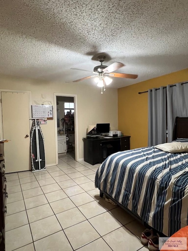 tiled bedroom featuring a textured ceiling and ceiling fan