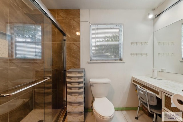 bathroom featuring a stall shower, toilet, and plenty of natural light