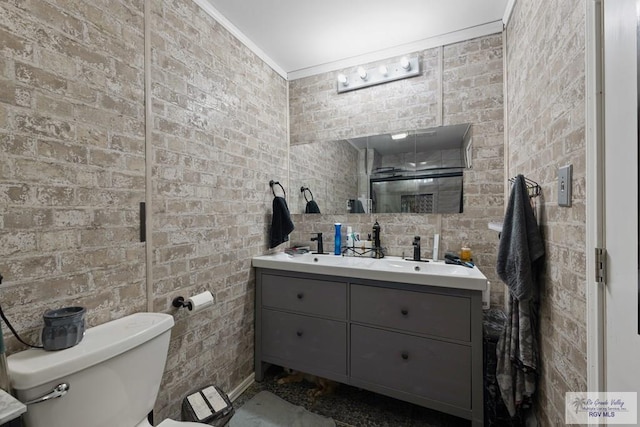 full bath with toilet, double vanity, and ornamental molding