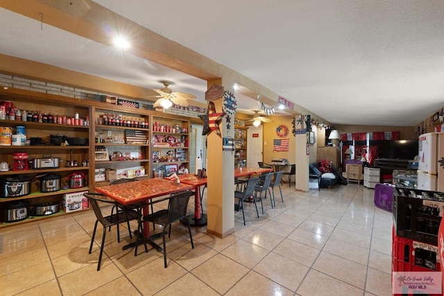dining area with light tile patterned flooring and a ceiling fan