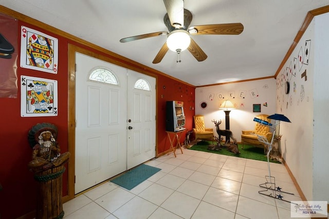 foyer entrance with crown molding, a ceiling fan, light tile patterned floors, and baseboards