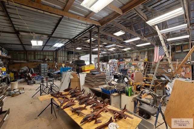 misc room with a workshop area and concrete floors