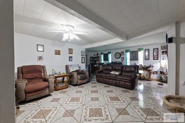 living room featuring beam ceiling, light tile patterned floors, and a ceiling fan