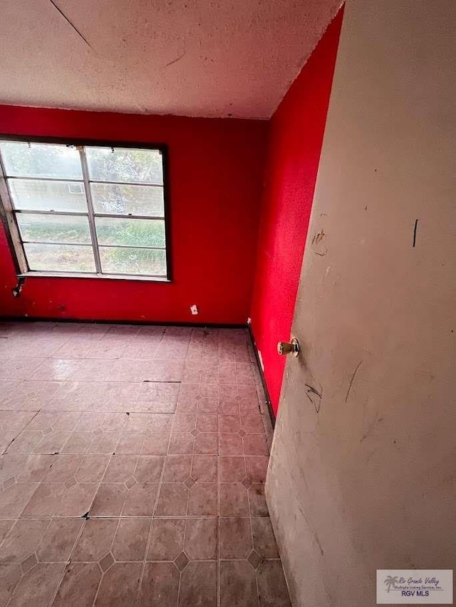 empty room featuring a textured ceiling