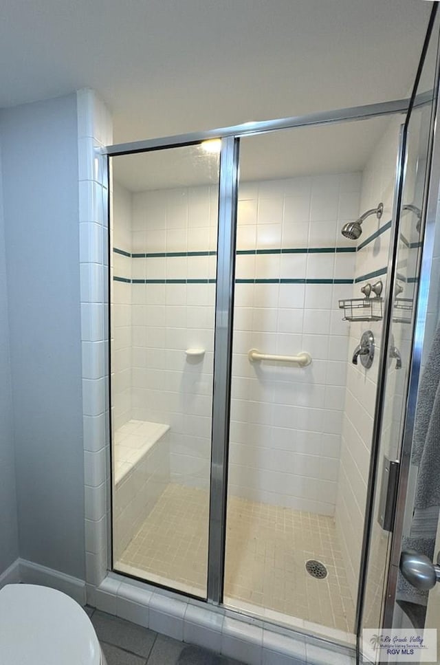 bathroom with toilet and walk in shower