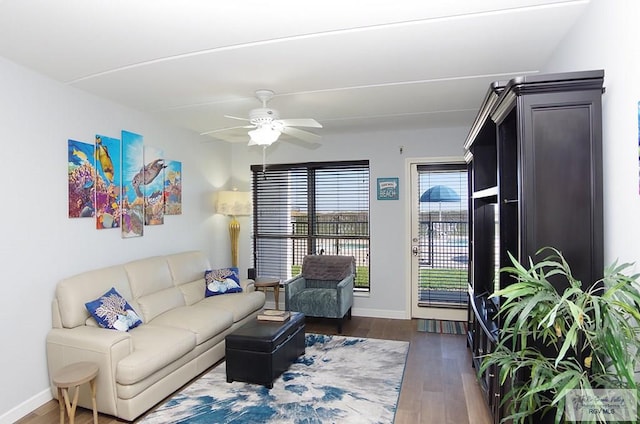 living room with dark hardwood / wood-style floors and ceiling fan