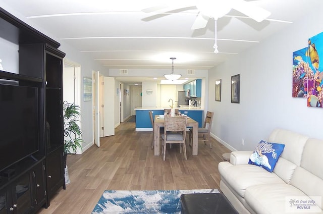 dining area with ceiling fan and wood-type flooring