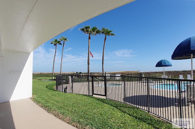 view of swimming pool with a patio area and a lawn