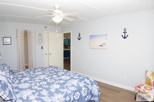 bedroom featuring hardwood / wood-style floors, ceiling fan, and a closet