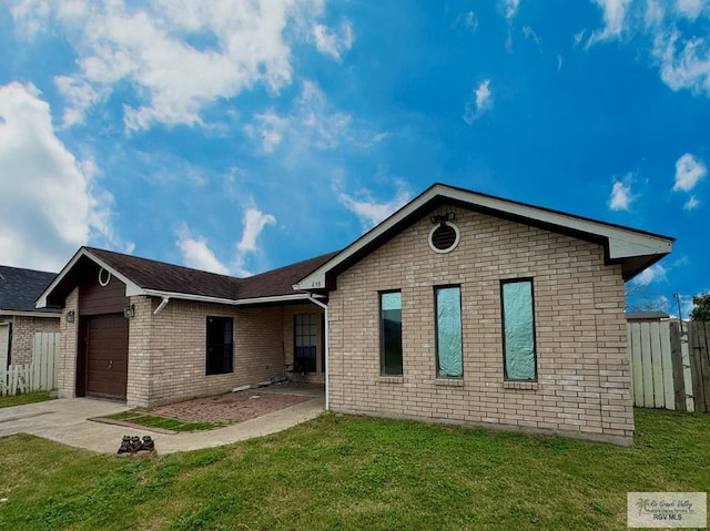 view of front of property with a garage and a front yard