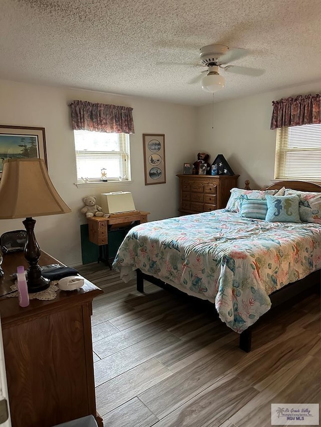 42 Cherokee Dr, Harlingen, TX 78550 - bedroom with light wood finished floors, a textured ceiling, and a ceiling fan